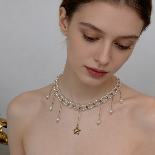 Minimal star pearl necklace styled with knit top for everyday wear