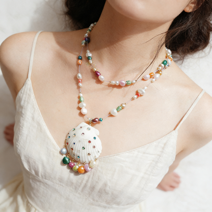 Handmade shell necklace with colorful beaded chain worn by model