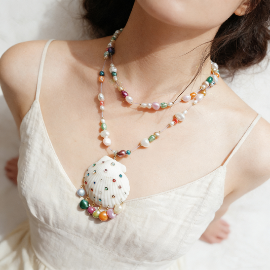 Handmade shell necklace with colorful beaded chain worn by model