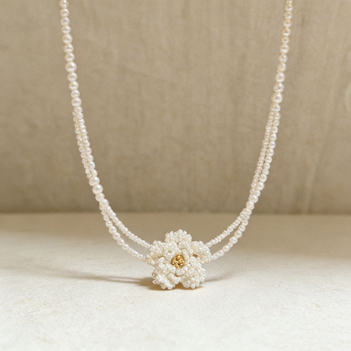 Close up of hand beaded flower centerpiece crafted with pearl style seed beads