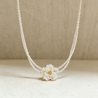 Close up of hand beaded flower centerpiece crafted with pearl style seed beads