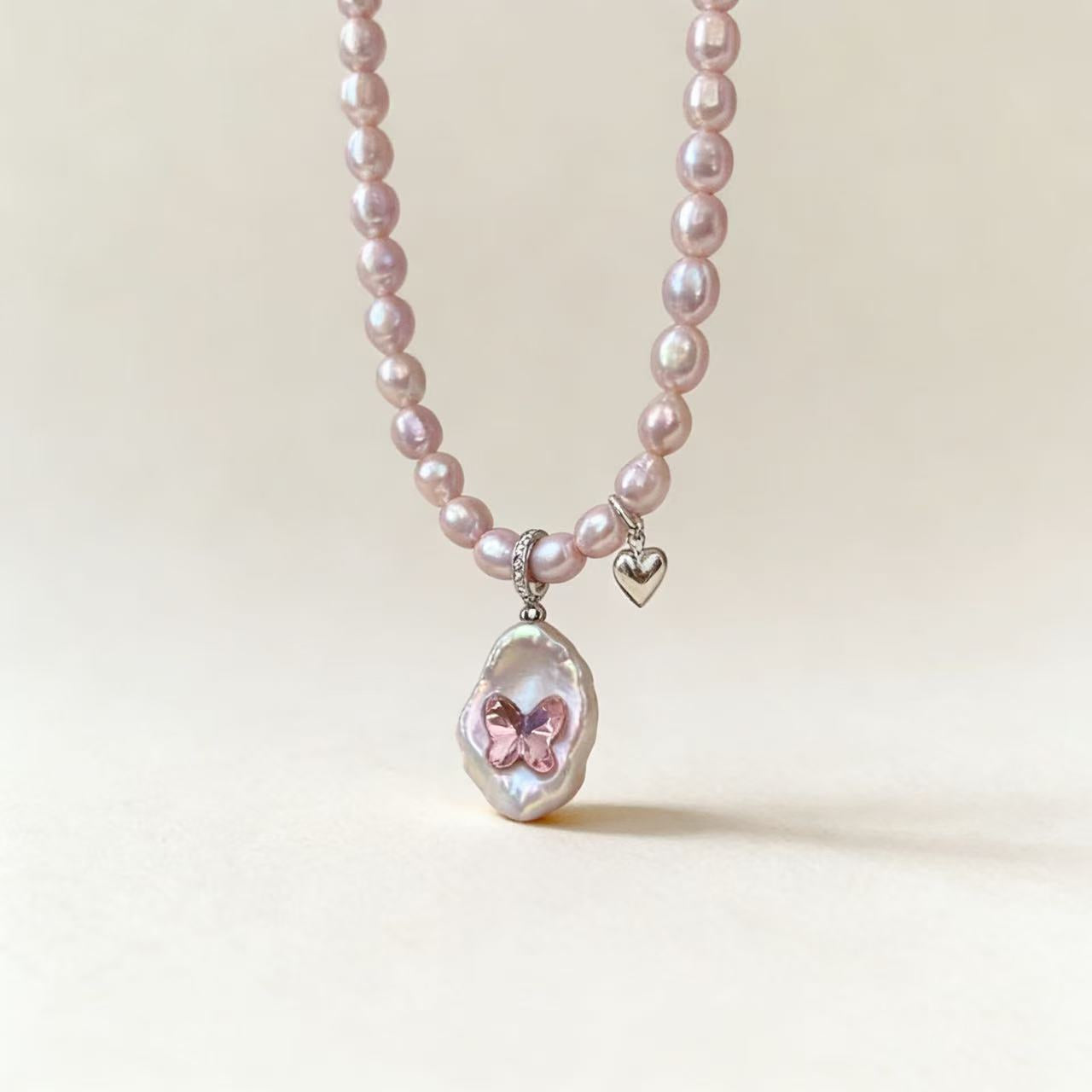 Pink pearl necklace with natural baroque pearl pendant and Swarovski butterfly