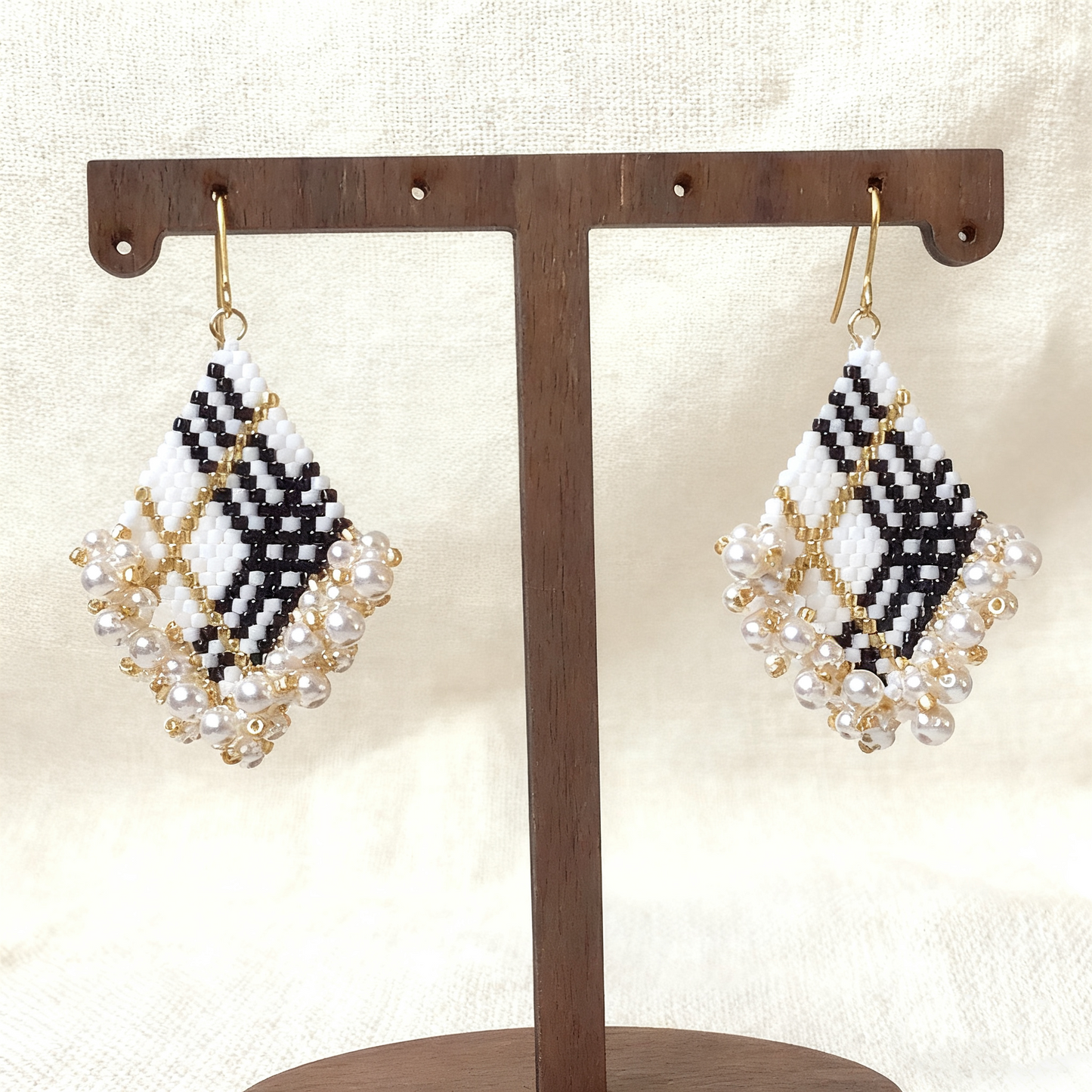 Close-up of square beaded earrings with intricate beadwork