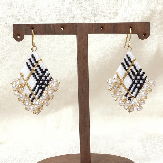 Close-up of square beaded earrings with intricate beadwork