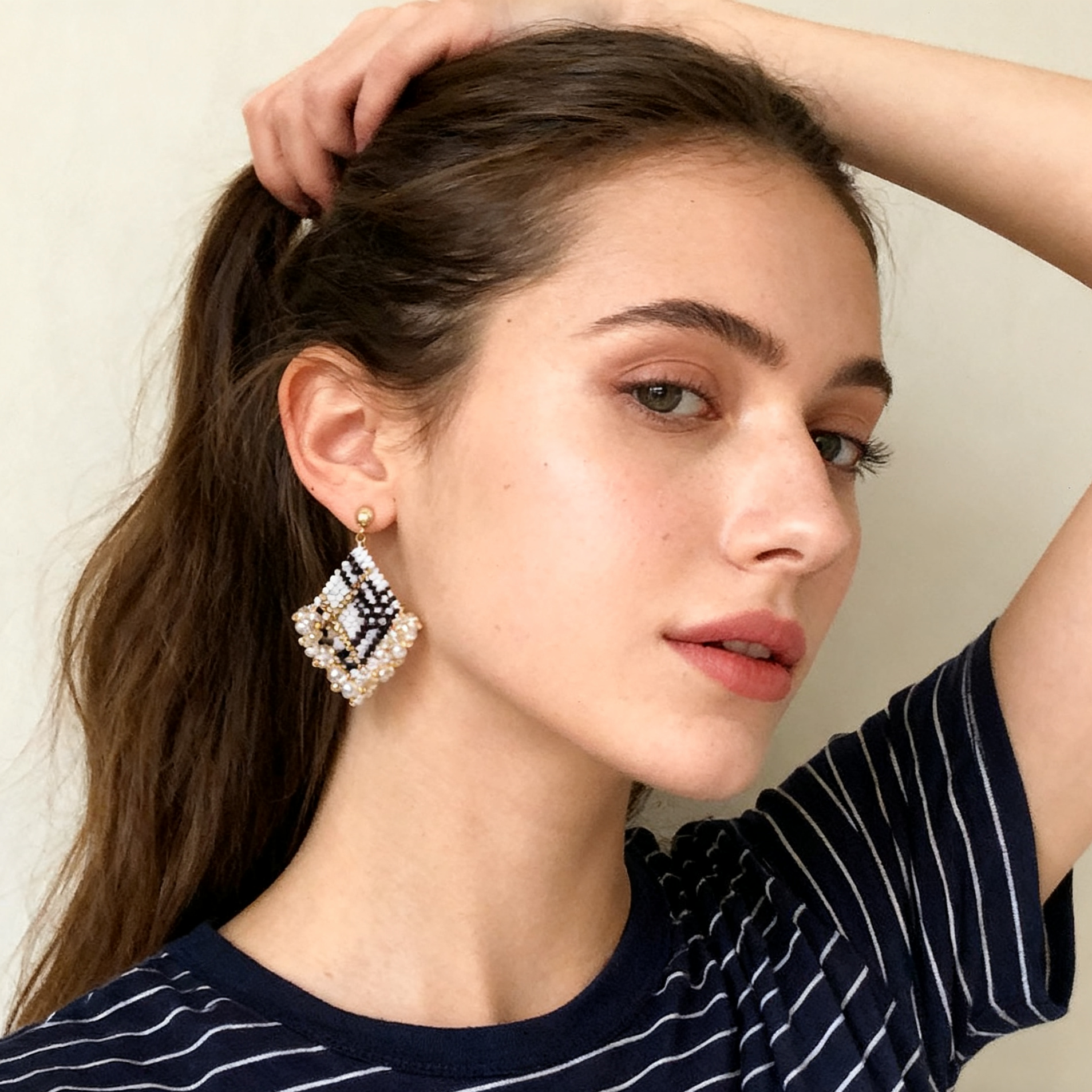 Handmade beaded square drop earrings worn on model