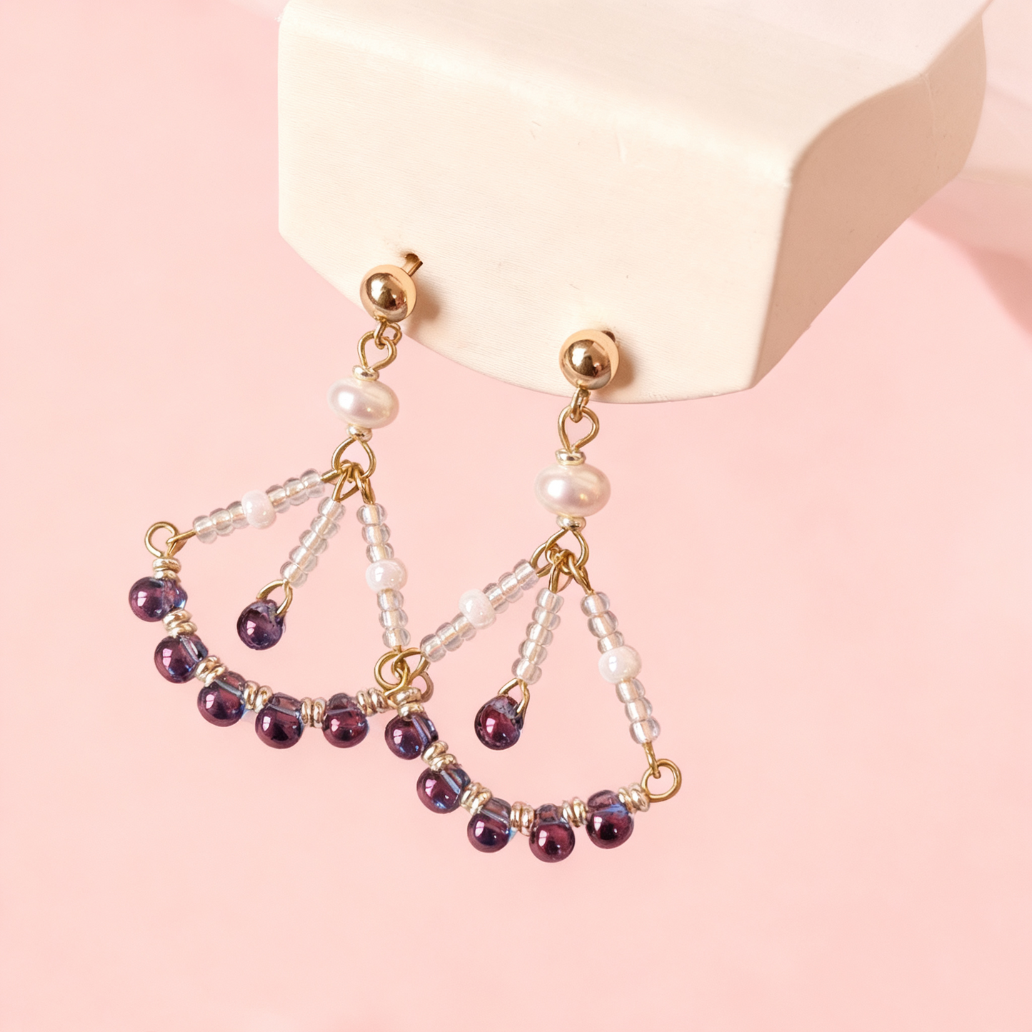 Close-up of beaded drop earrings with pearls and blue beads