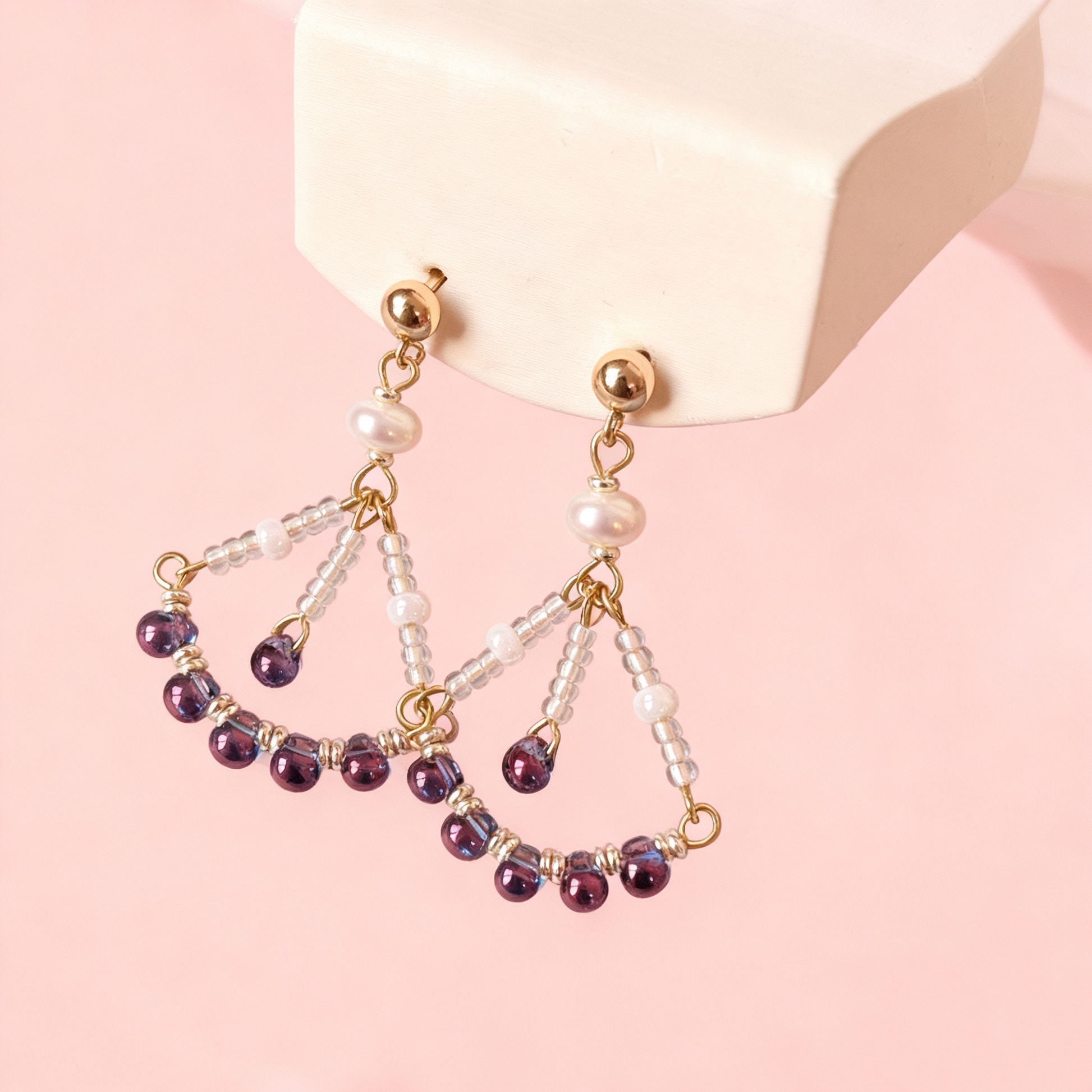 Close-up of beaded drop earrings with pearls and blue beads