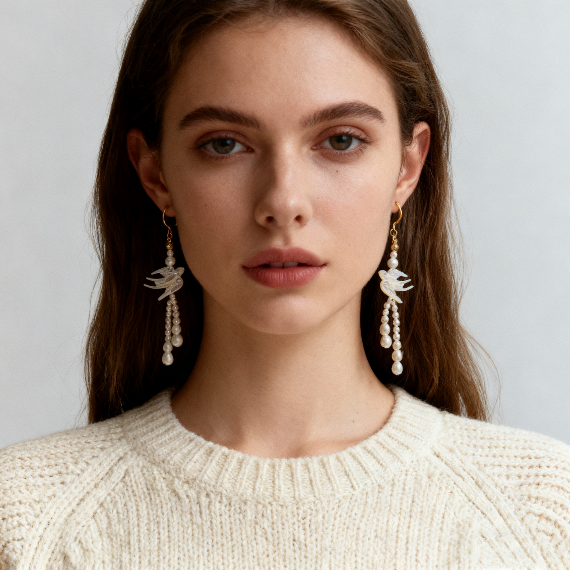 Swallow shell carved pearl drop earrings worn on ear