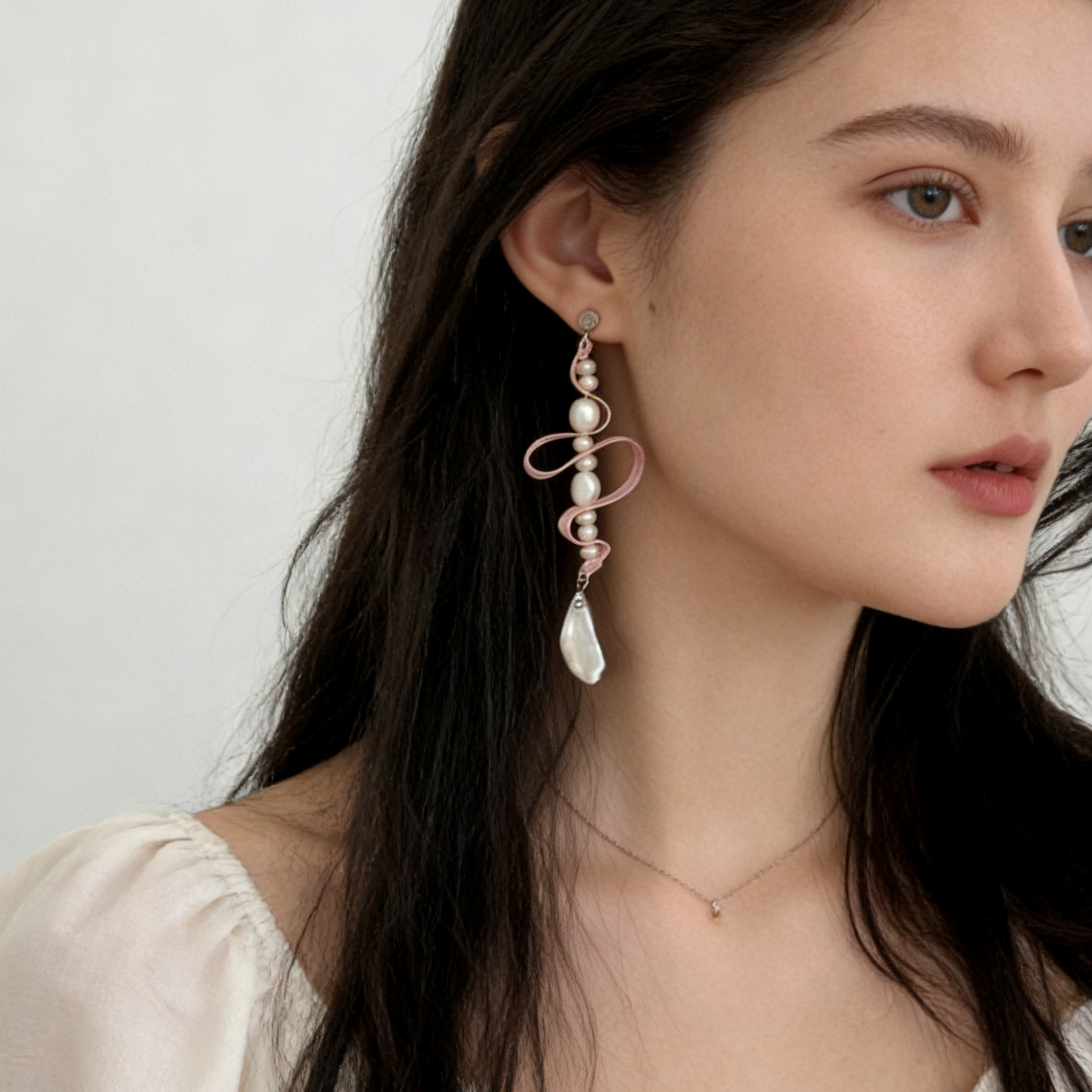 Natural baroque pearl drop detail on ribbon earring