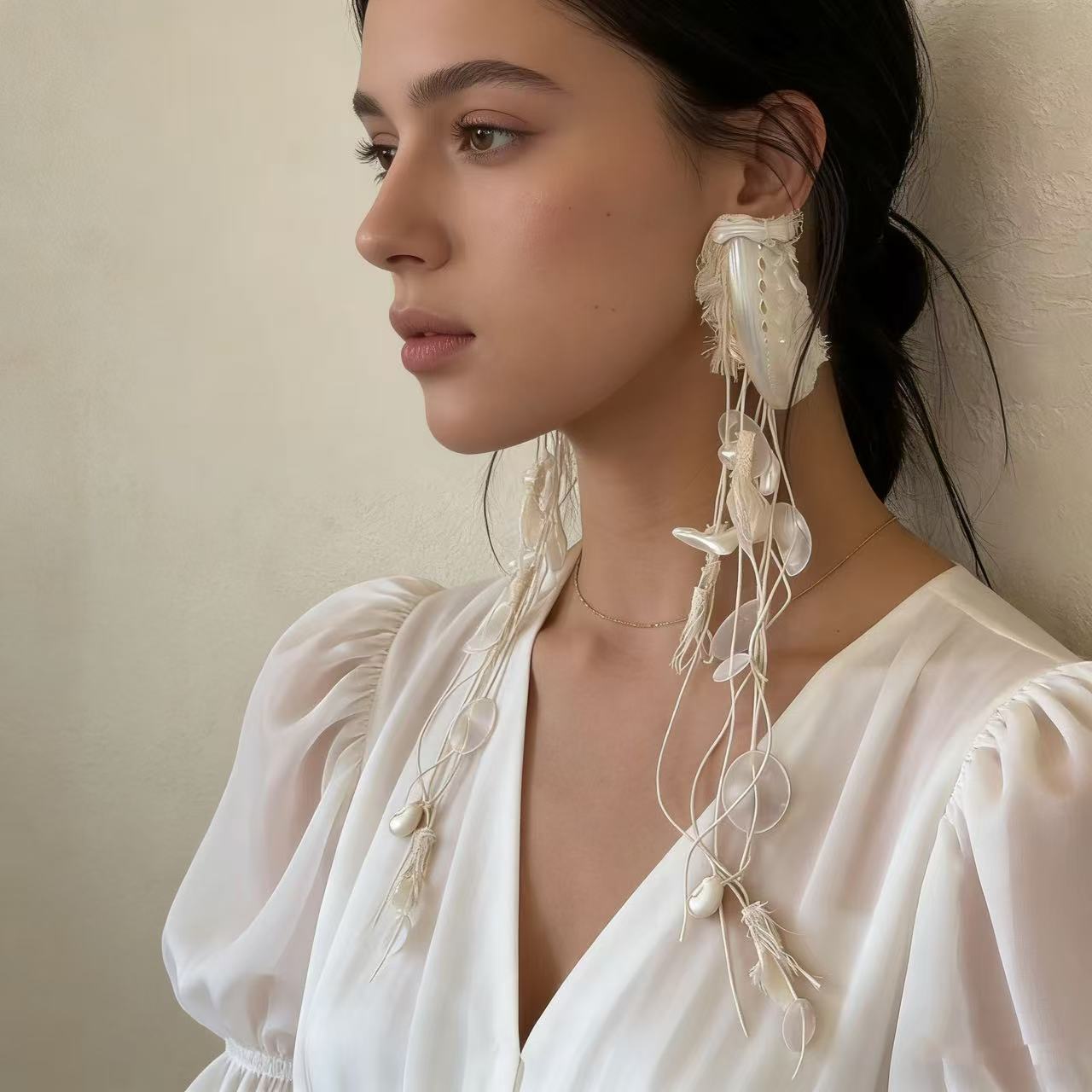 Asymmetric shell earring with cascading organic drop design