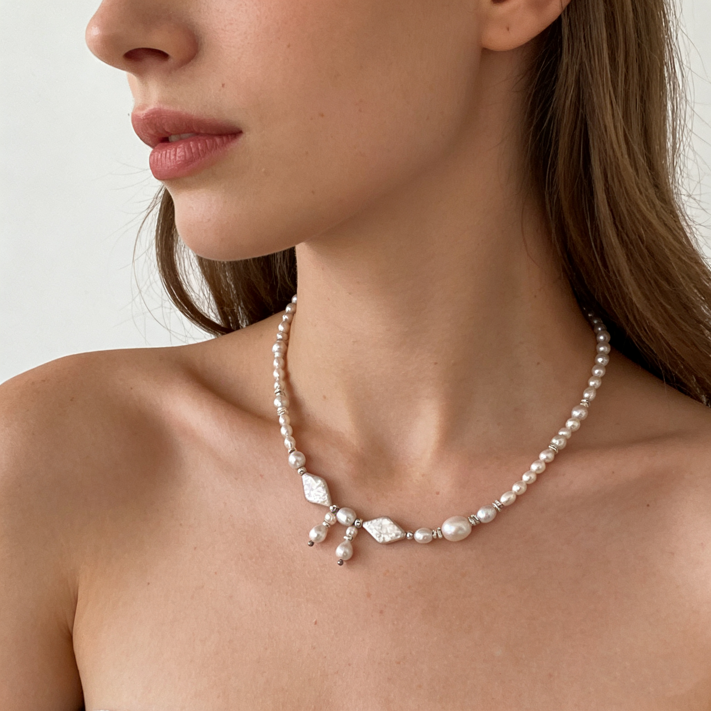 [main detail] detail on [key design] necklace