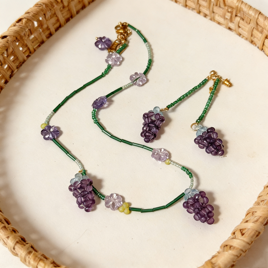 Detail view of whimsical grape charm necklace design