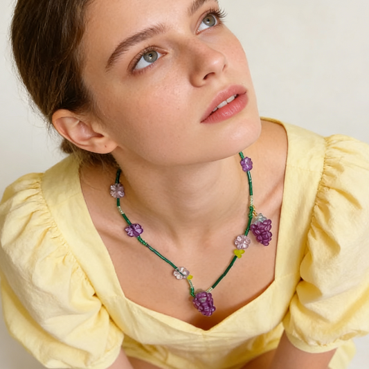 Playful beaded grape charm necklace worn on model