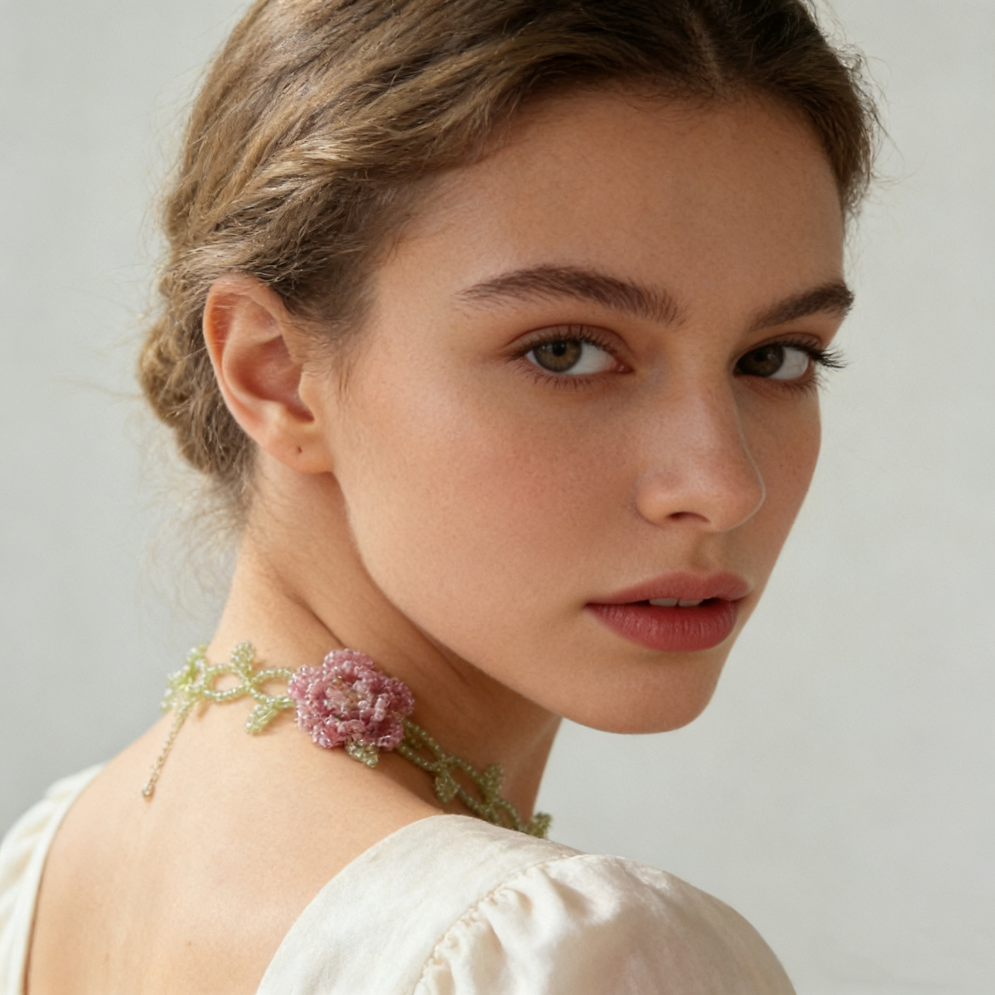Hand beaded floral vine necklace worn on model neckline