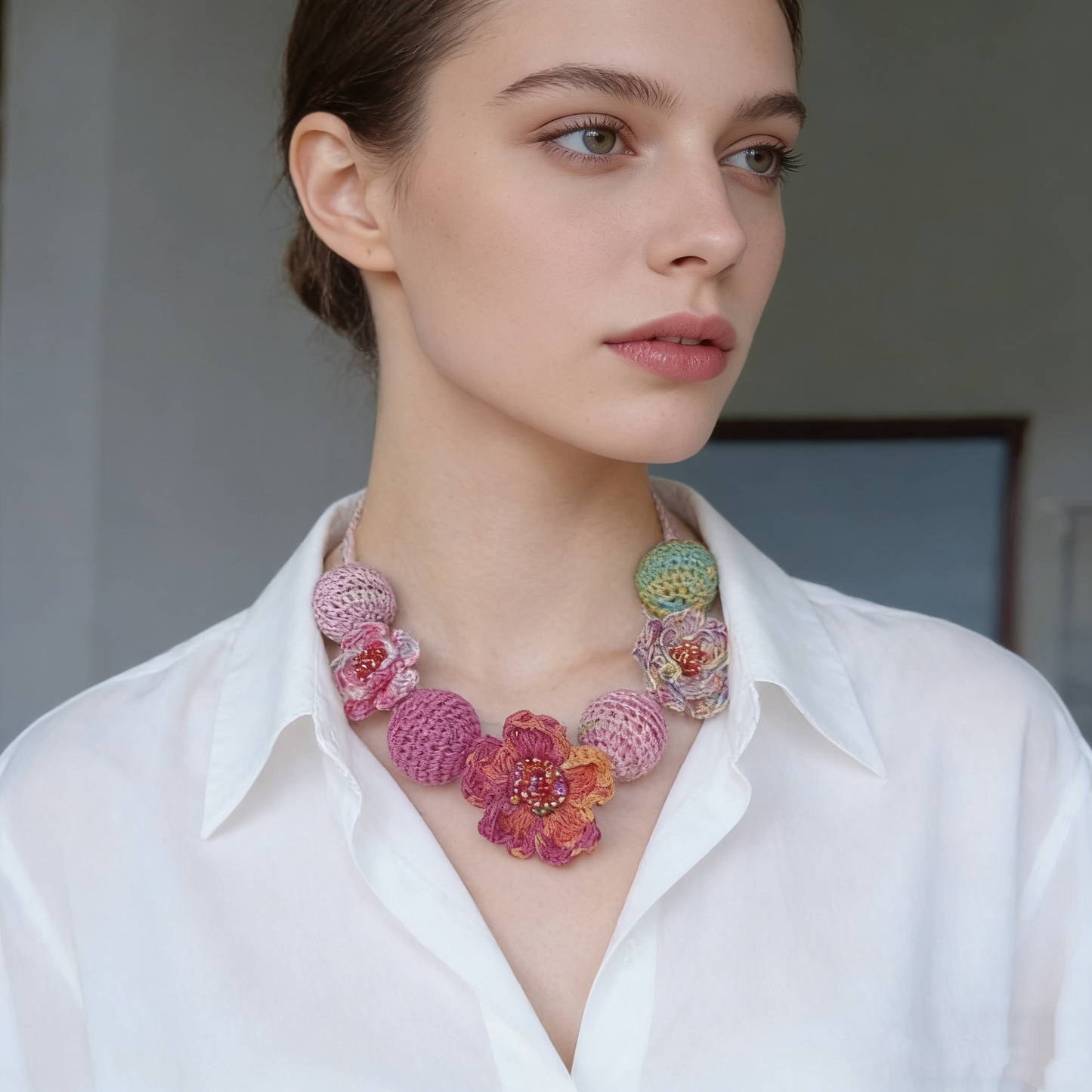 Handcrafted textile necklace with crochet flowers and colorful bead details