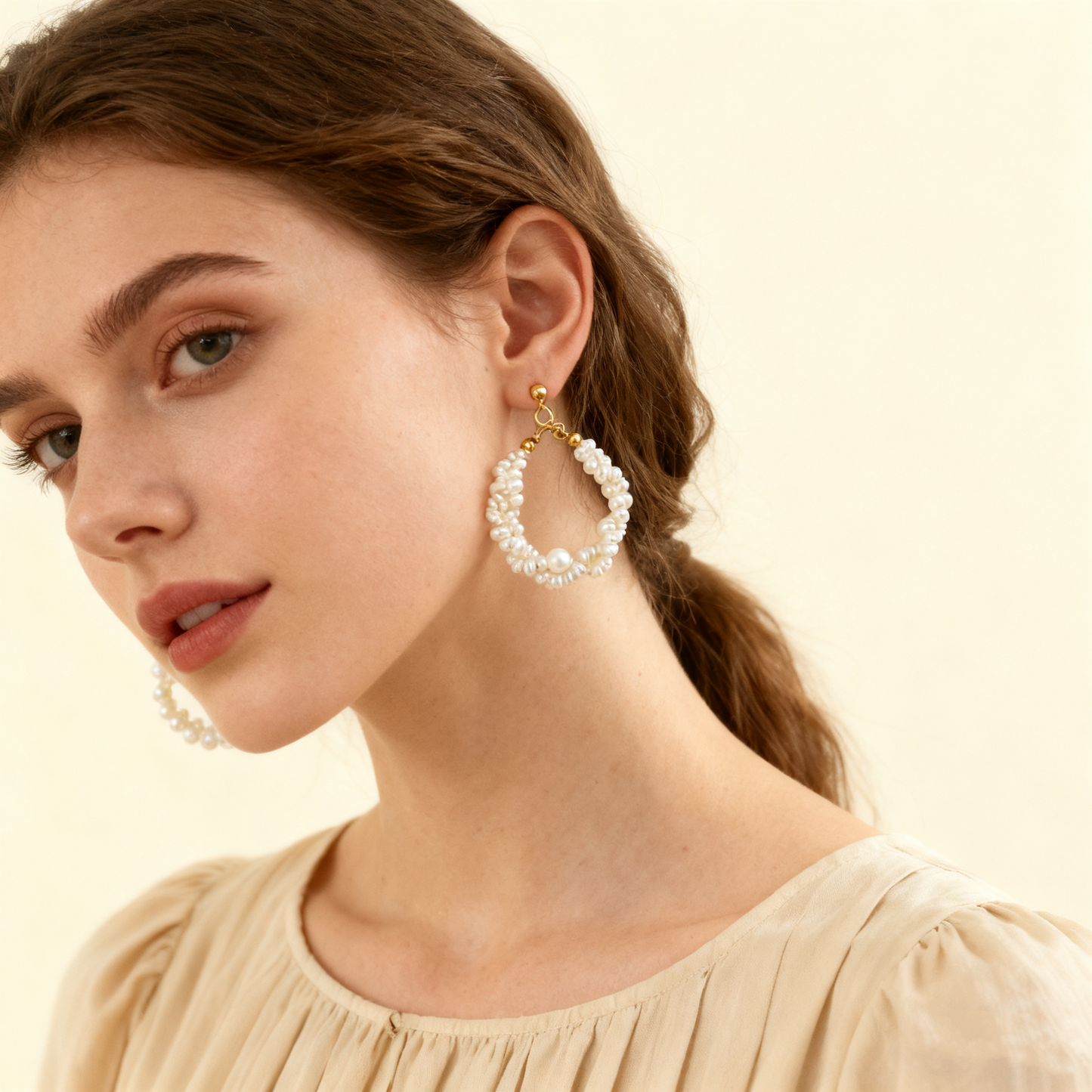 Natural pearl hoop earrings worn by model