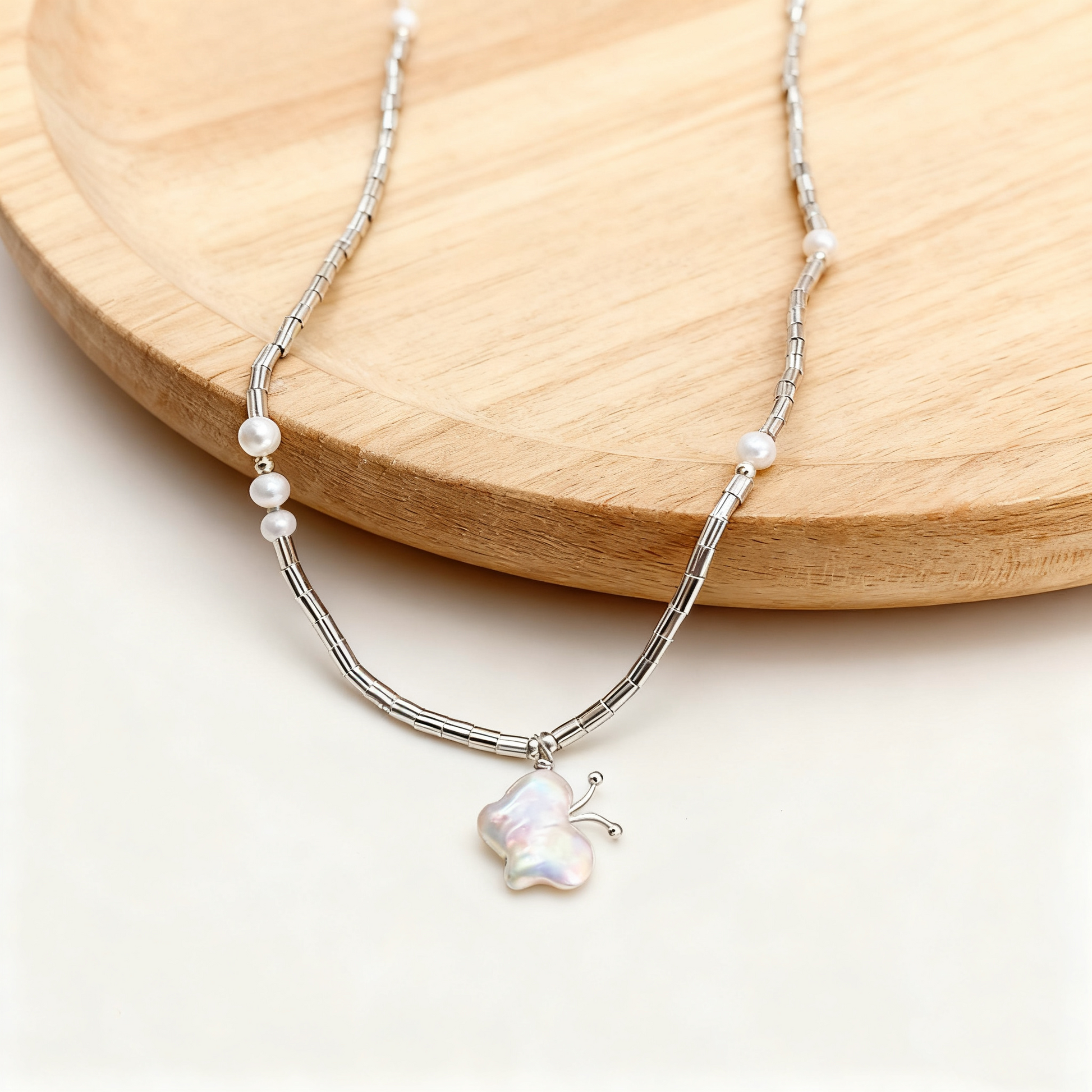 Simple baroque pearl butterfly necklace on neckline