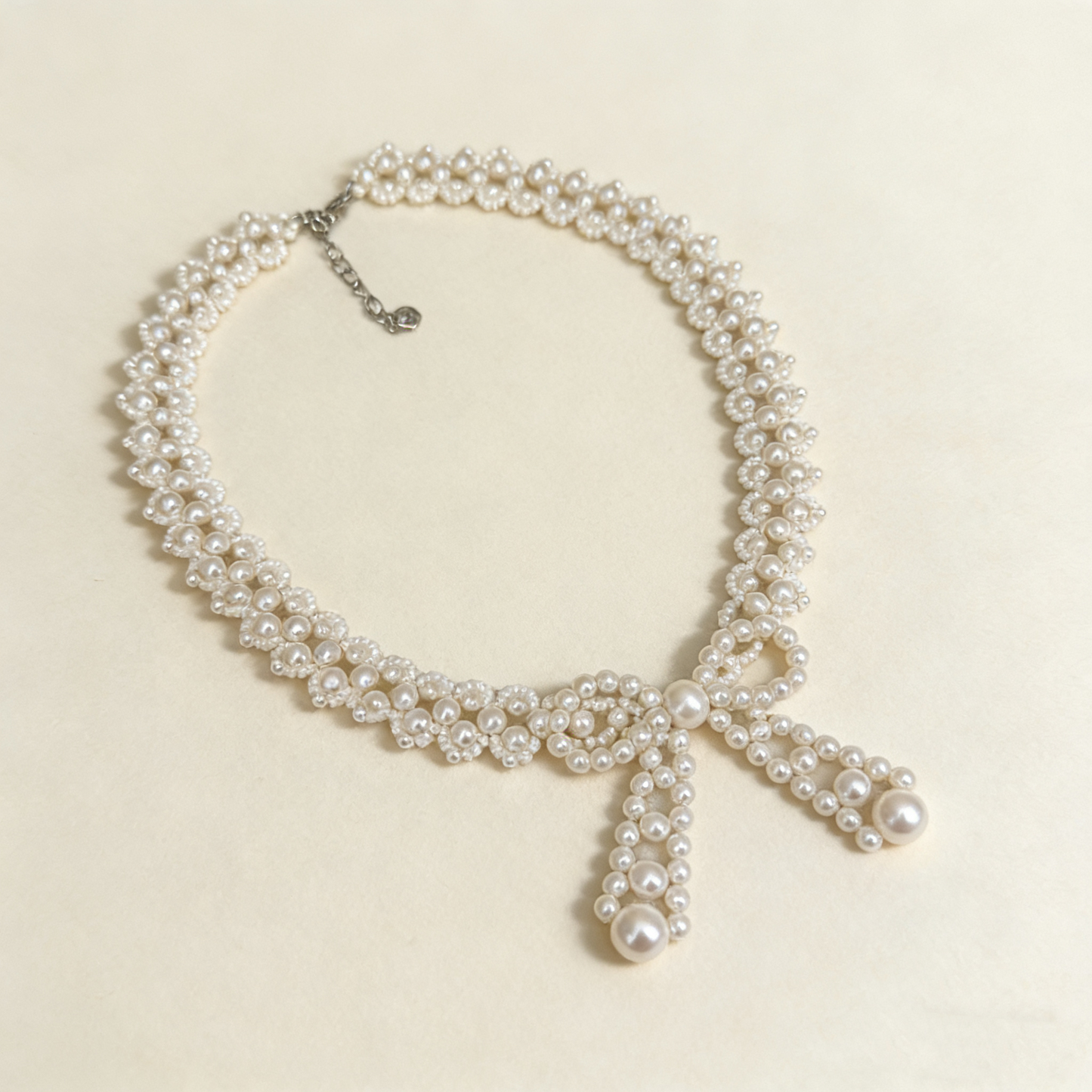 Imitation pearl bow necklace close up detail