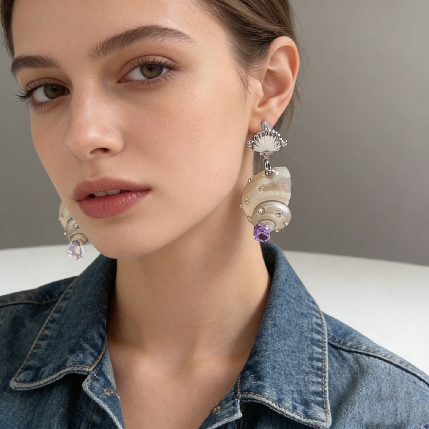 Shell pearl drop earrings with crystal details worn on model
