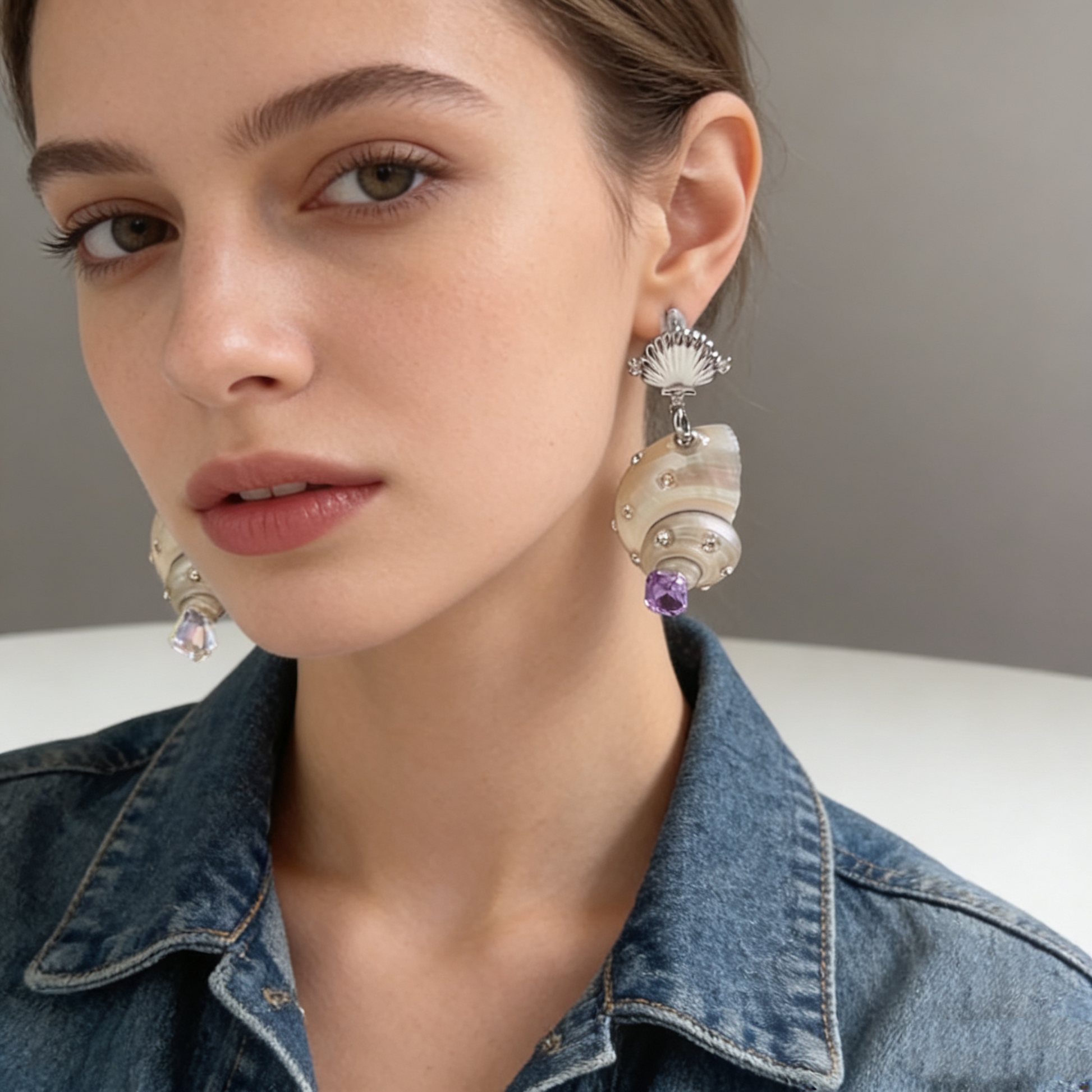 Shell pearl drop earrings with crystal details worn on model