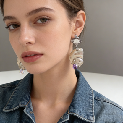 Shell pearl drop earrings with crystal details worn on model