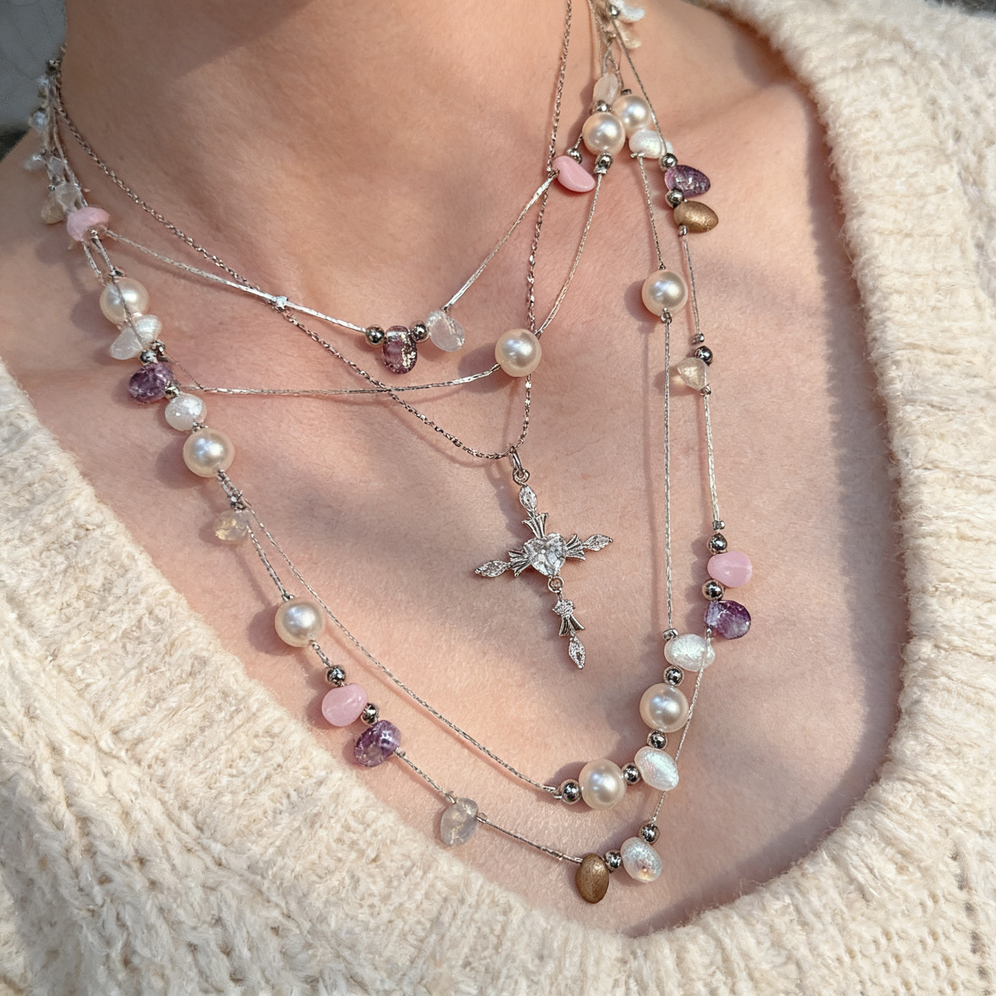 Handcrafted pearl necklace with cross detail close up