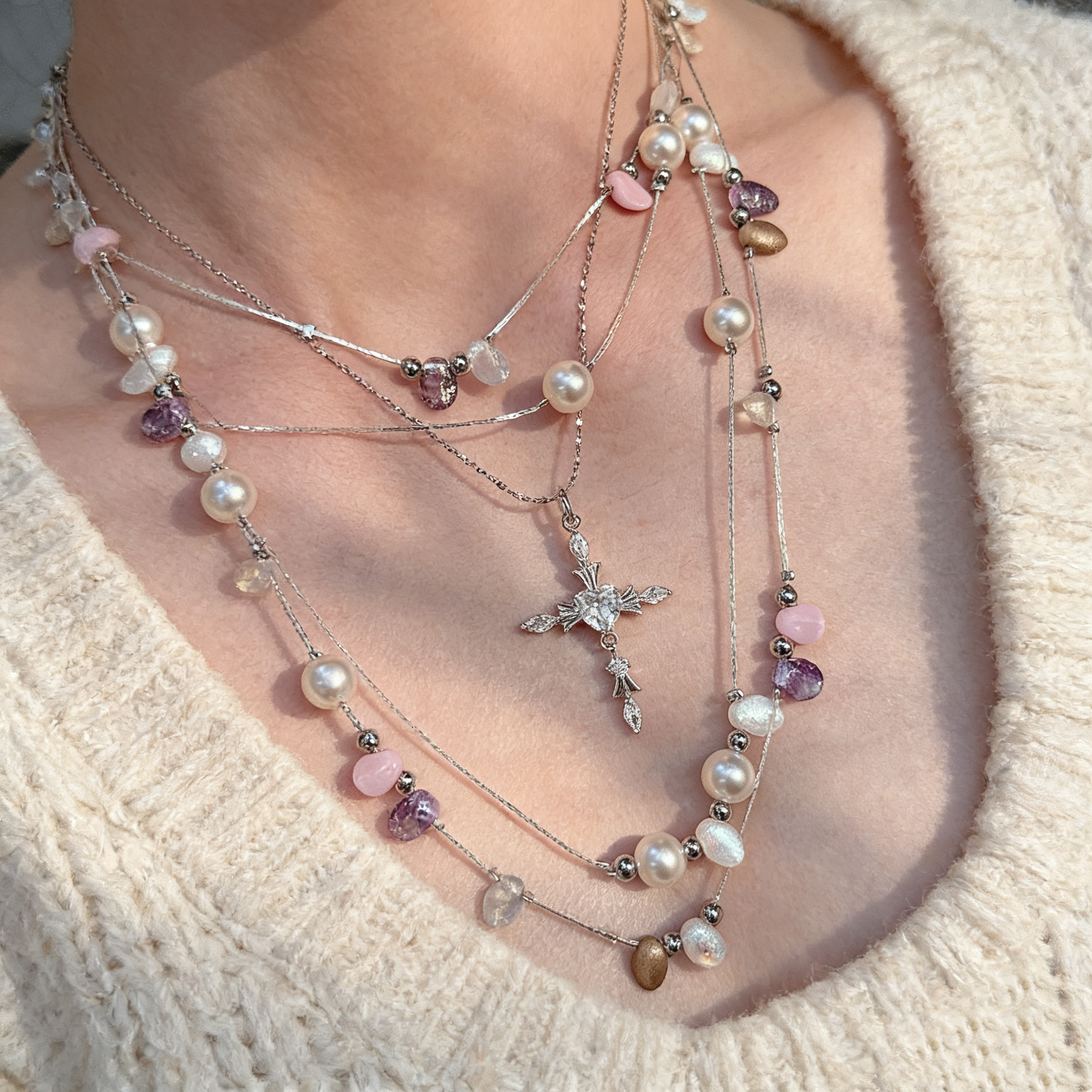 Handcrafted pearl necklace with cross detail close up